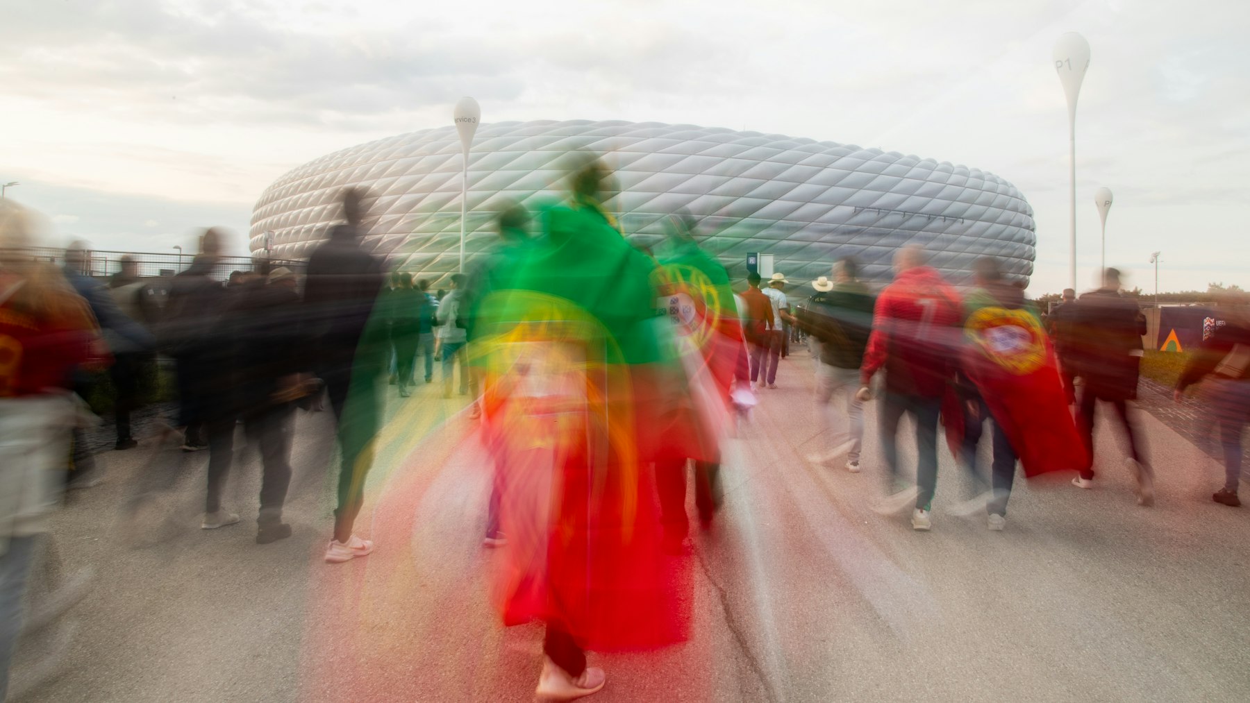 Soccer supporters walking toward a stadium before kickoff on a real city matchday